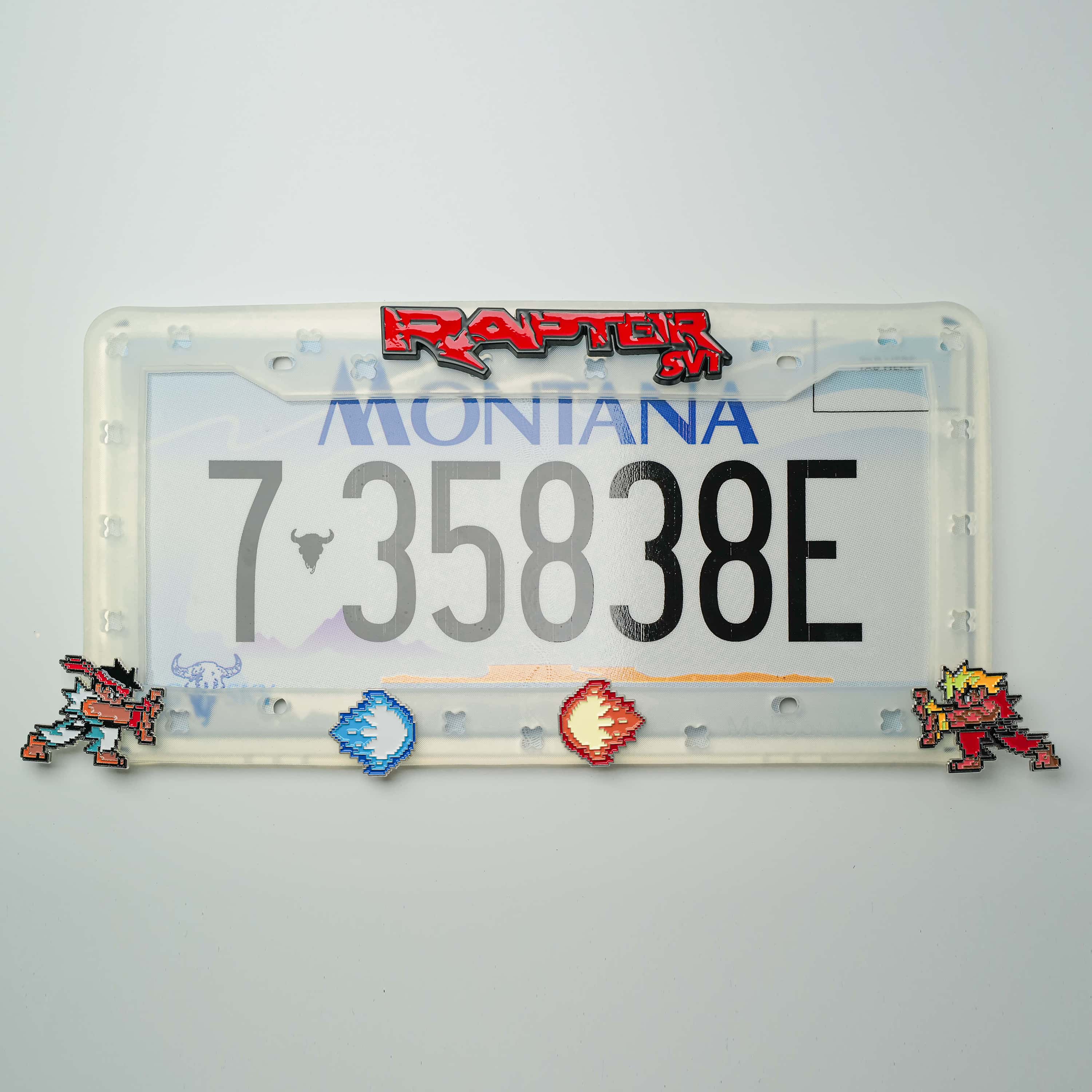 Makoauto clear DIY car license plate frame featuring retro 8-bit arcade fighter shoe charms installed over a state plate.