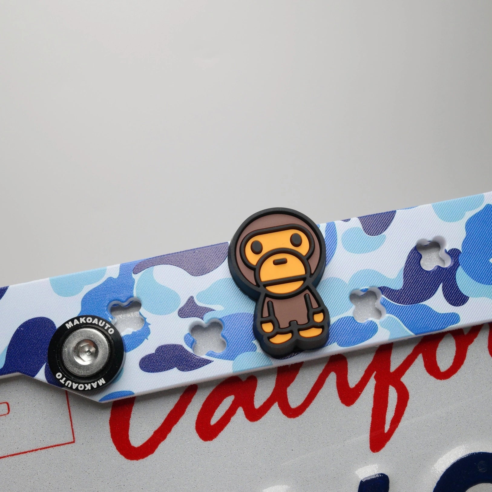 Close up of the clog style holes tightly holding the blue hypebeast custom charms