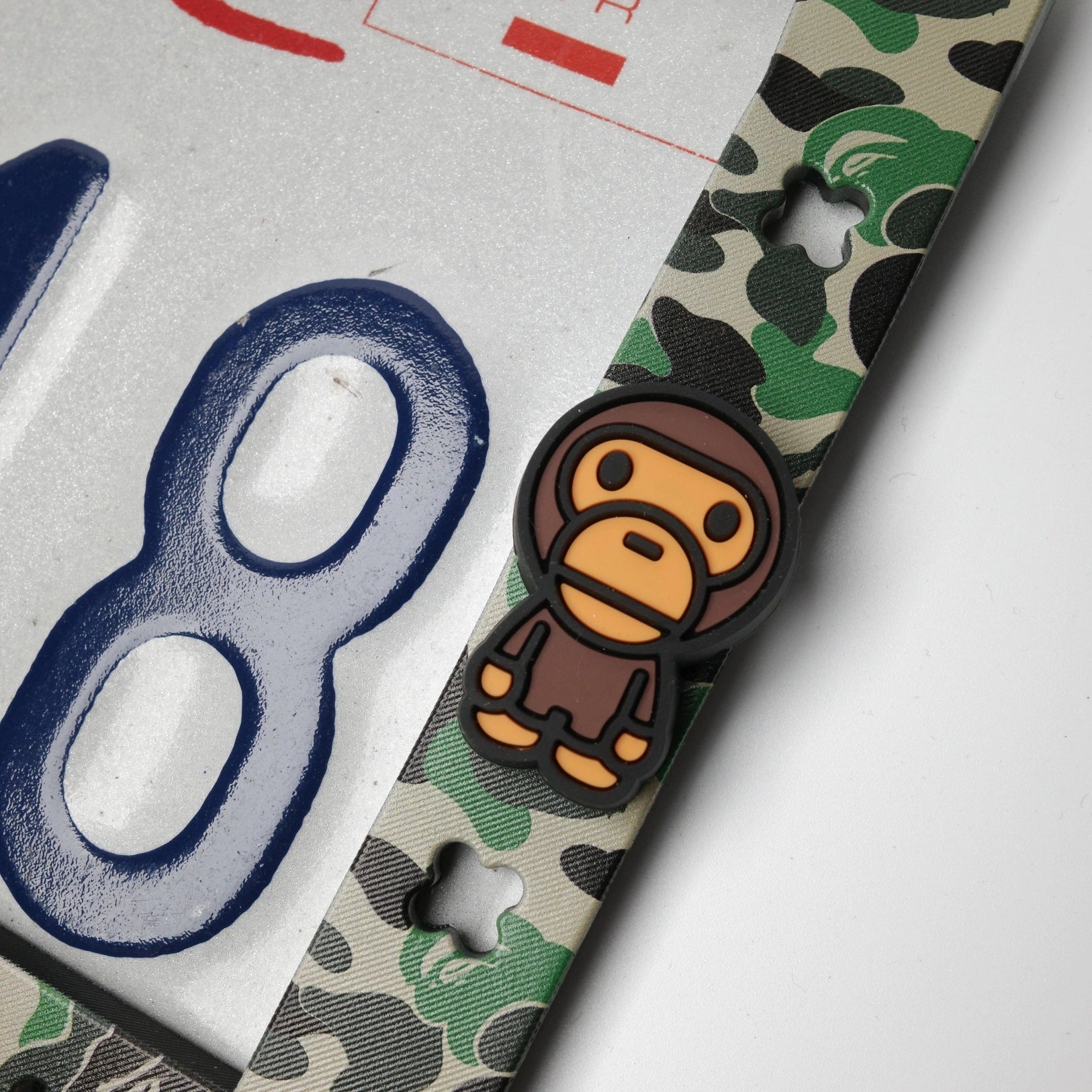 Close up showing the secure fit of custom hypebeast charms on the green Makoauto frame