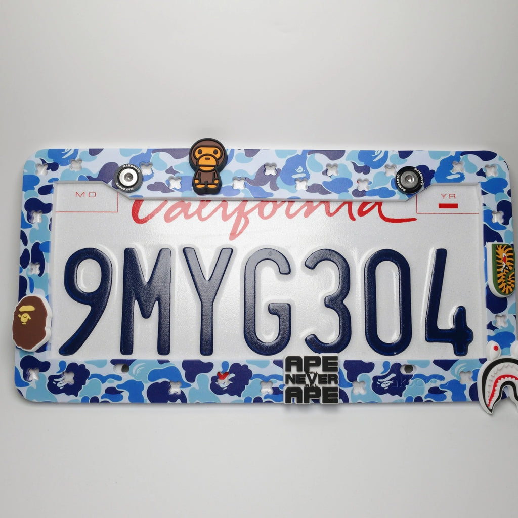 Full view of Makoauto ocean blue camo UV printed license plate frame loaded with custom ape charms