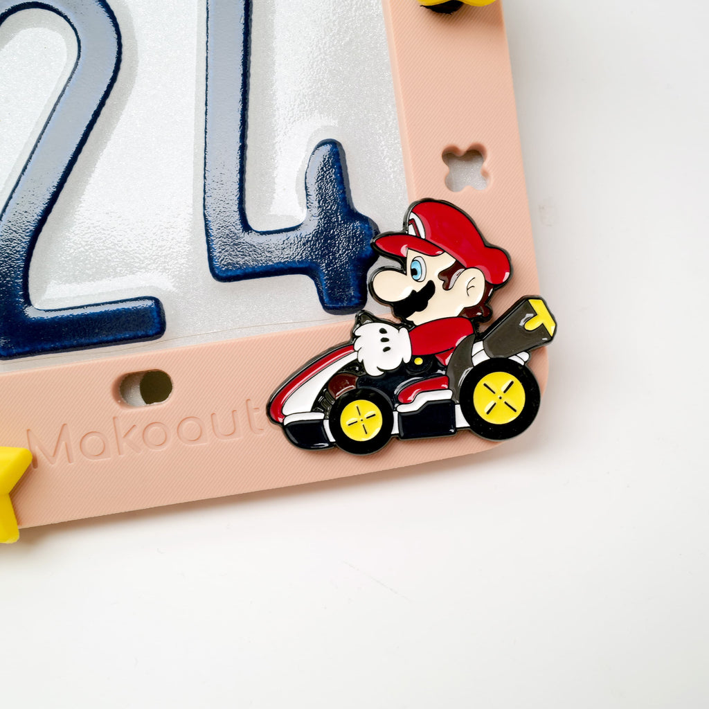 Close up of retro gaming power-up shoe charm on pink frame